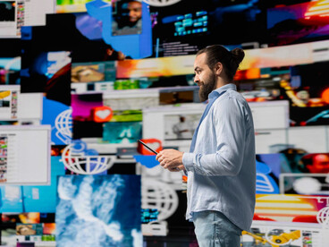 Person surrounded by multiple screens, feeling overwhelmed by the digital world