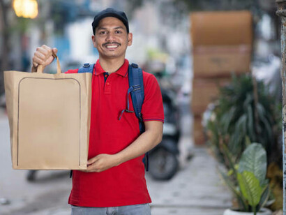 An Indian food delivery boy navigating city streets, symbolizing the rapid rise of online food services in everyday life, India