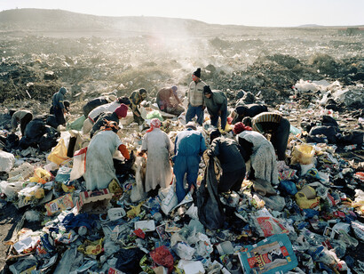 Poor people looking for food in a landfill
