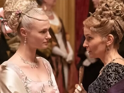 Cressida Cowper and her mother from Bridgerton wearing elaborate gowns and intricate hairstyles, reflecting femininity expressed through layers of embellishment