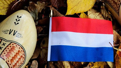 The flag of the Netherlands along with its iconic cultural footwear the clog