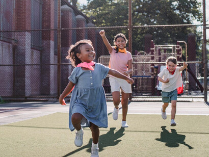 In this vibrant playground, the children's joyful interactions serve as a beautiful reminder of the power of empathy and teamwork
