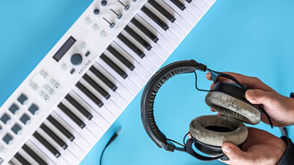 The essence of amapiano music with an image of headphones held by a male against a backdrop of musical keys and a piano, capturing the soulful rhythm and vibe of amapiano