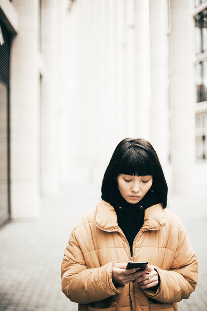 A woman looking at her smartphone, while outdoors. Western social media platforms have faced stricter opposition in Asia and the Middle East. Of the 46 countries in the region, 30 have recorded some form of social media restriction since 2015