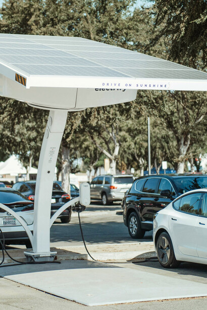 Electric cars charging at stations powered by solar energy