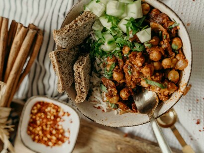 A vibrant plant-based bowl featuring chickpeas and fresh vegetables, captured in soft natural light
