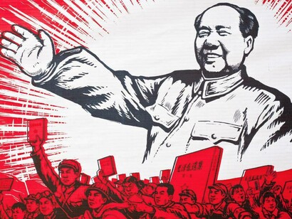 A poster depicting an older Chairman Mao promoting Maoism