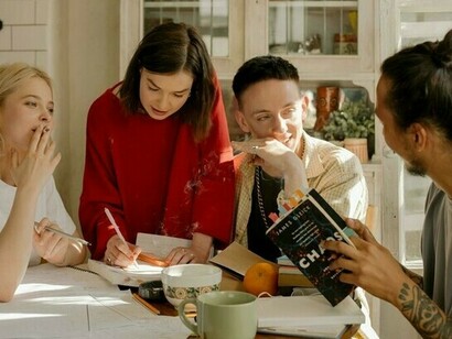 A group of friends sits at a table and has an interesting discussion