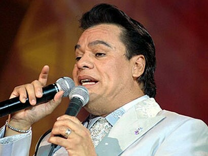 Juan Gabriel singing with two microphones
