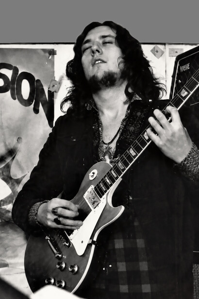 Marcello Capra on stage, captured during an energetic live concert performance
