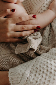 A mother tenderly cradles her child, a reminder that amidst challenges and choices, love remains the guiding force