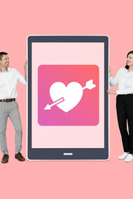 A couple viewing a dating app on a tablet, exploring online dating together