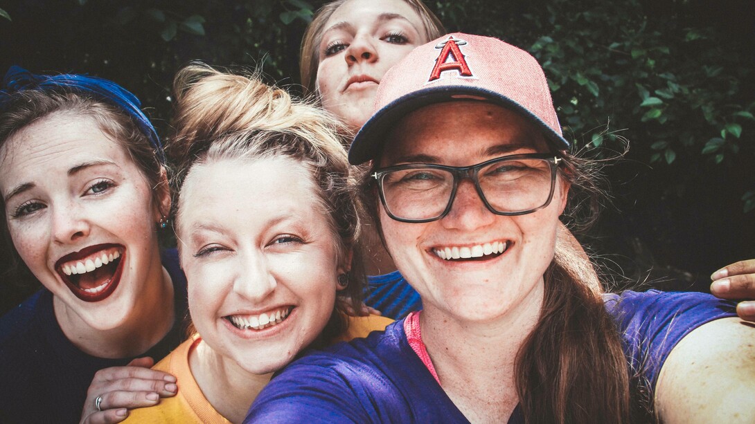 A group of friends in good spirits and expressing their happiness