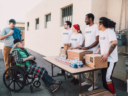 Volunteers distribute water and food to those in need