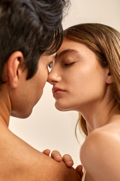 A shirtless couple embracing each other in a moment of intimacy