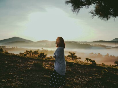 Dalat, Lâm Đồng, Vietnam a woman standing on a mountain taking in the scenic view