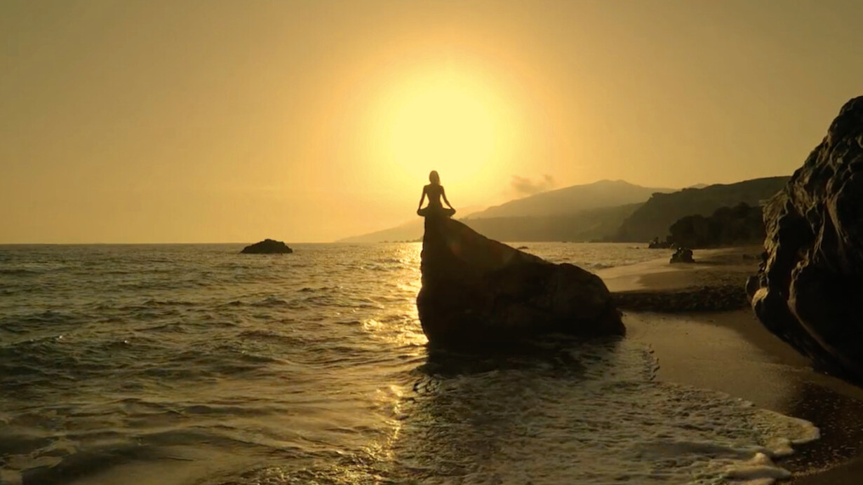 As the sun sets in a golden embrace, she finds solace on the rock, reminding us that moments of silence can lead to profound self-discovery