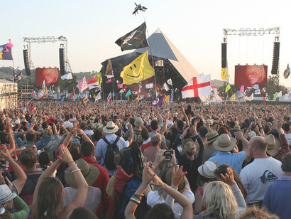 Festivalgoers gathered before the main stage at the Glastonbury Festival in England, enjoying the lively atmosphere and performances