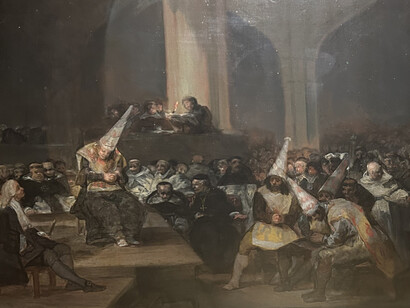 The painting "Scene of the Inquisition" by Francisco Goya is a masterpiece of Spanish art of the 18th century. This work represents a scene from the Spanish Inquisition, where a group of men dressed in black and hoods are seen surrounding a woman being interrogated