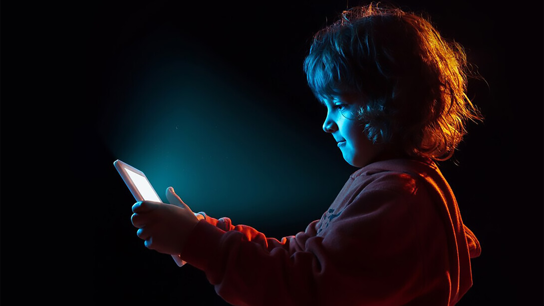 A boy appears frustrated while vlogging with a tablet, capturing the emotional impact of technology on children and the challenges posed by digital distractions
