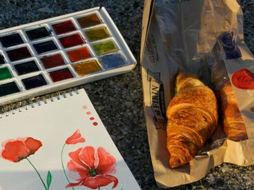 Materiais de pintura e um caderno aberto revelam o hábito de registrar paisagens e ideias sempre que a inspiração surge. Para François, cada caminhada pela cidade é uma oportunidade de criar