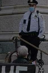 Security guard at a gathering in favor of asylum seekers, New York City, 2020