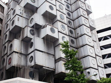 The exterior of the Nakagin Capsule Tower in Tokyo, Japan, showcasing its distinctive capsule apartments