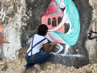 Marie-joe Ayoub painting a wall