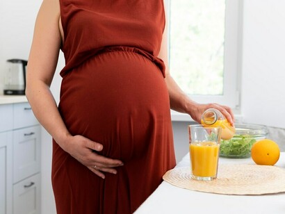 A pregnant woman prepares a healthy dinner, nourishing both herself and her baby