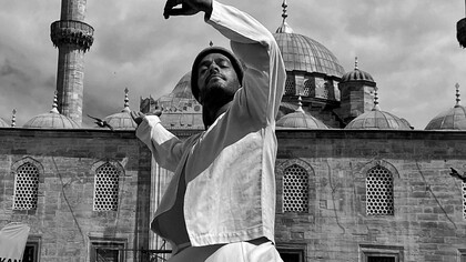 A dervish by a mosque 