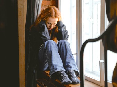 Menina triste na janela