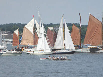 The paddle steamer “Freya” in a group of ships in front of the Friedrichsorter lighthouse, Kiel Week 2023