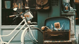 A vintage bicycle rests outside a charming shop, evoking a sense of classic beauty