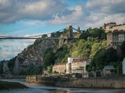 Bristol, England, United Kingdom – a bridge spanning the river against a town and mountain landscape
