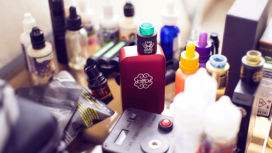 A collection of vape machines and liquids