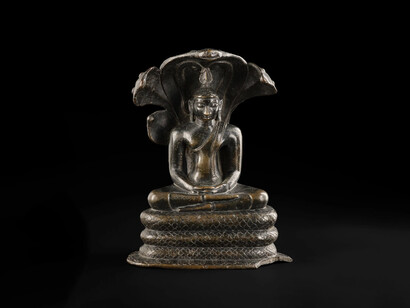 The Buddha continued to meditate for seven weeks after his awakening. In the sixth week there was a rainstorm and the nāga (serpent) king Muchalinda sheltered him with his hood. Depicted here in bronze, from Sri Lanka, 11th century, A.1901.268.41. Courtesy of National Museum of Scotland