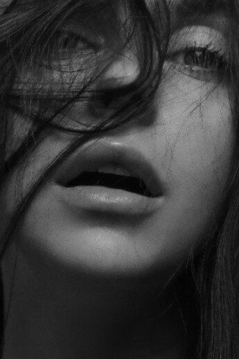 A captivating image of a black-haired woman, radiating feminine beauty and subtle sexiness