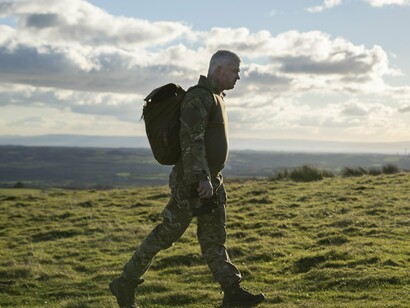 The soldier’s journey over native ground evokes a broader return: of focus, of limits, of forgotten priorities