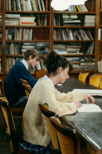 A girl is studying together in a library