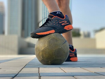 A footballer pausing with complete control over the ball, symbolising the confidence needed to pursue greatness