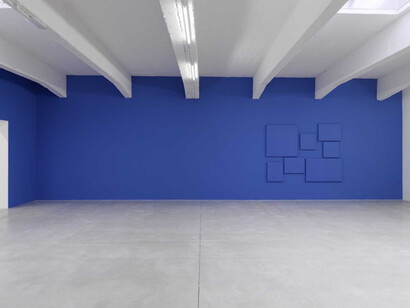 de-finition/method “elements in a spiral”, 1976 , Paint on canvas, Variable dimensions according to the actualization , Here: actualization on blue wall: 355 x 365 cm. Courtesy Perrotin. de-finition/method: a series of small canvases—though other supports can also be used from time to time—are hung in an off-center spiral. it uncoils and may reach the edge of the wall. all of its elements are painted the same color as the wall. although the number of supports is not pre-determined, the spiral that they create should be readable at a glance. the creation and installation of the spiral are the charge- taker’s responsibility, and he or she can change the work at will within the rules given above. 
