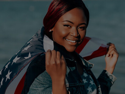With a dignified aura, a Black woman gracefully clutches American flags in her hands, symbolizing a profound connection to her heritage and nation