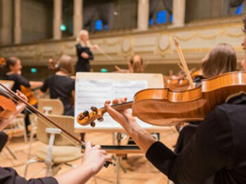 An orchestra performing their piece, with violas featured prominently, in Bern, Switzerland