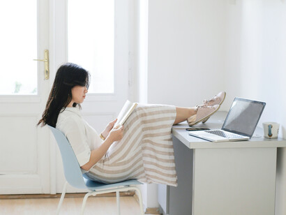 A girl at her desk reading a book