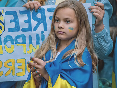 In Germany, a poignant demonstration unfolds as protesters wave Ukrainian flags, expressing their fervent opposition to the war in Ukraine