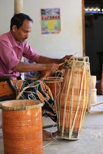 A man is busy making a traditional drum. Different skins are used for the two drum heads to produce contrasting tones. Village Kuragala in Sri Lanka