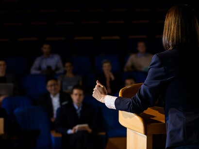 Behind the podium, policy becomes performance—crafted far from the pain it governs