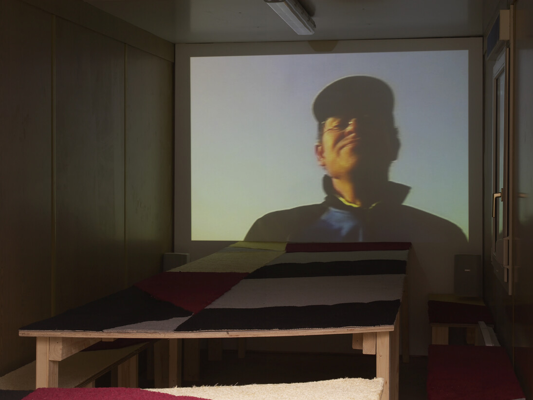 Erik van Lieshout, Rotterdam – Rostock, 2006, 
DV transferred to DVD (17 minutes),  Shipping container, wood, carpet Courtesy the artist and Maureen Paley
