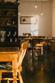 A warm, vintage café interior bathed in natural light, representing the charm and elegance of Japan's traditional kissaten culture