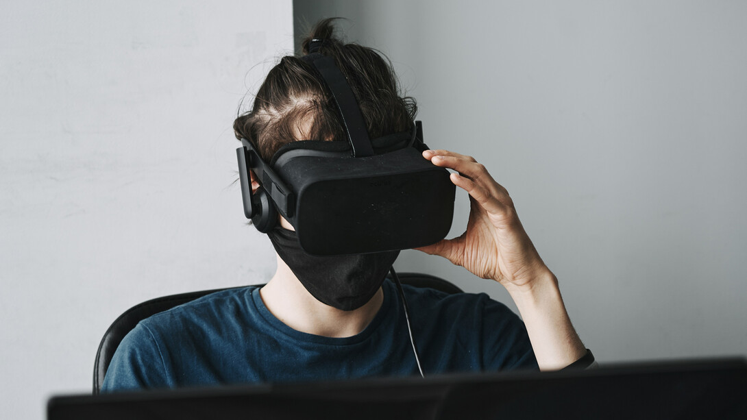 A man in a virtual reality helmet, isolated from the world